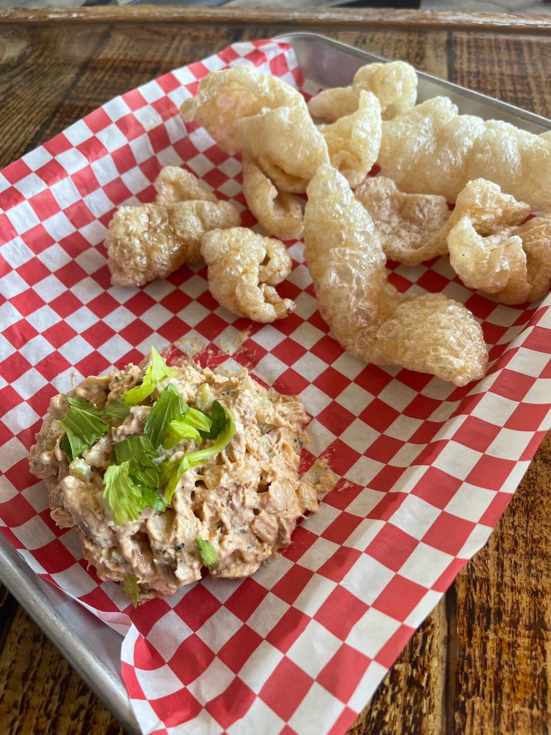 A fried entree and salad from PiNK PiG Southern BBQ